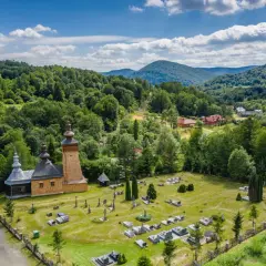 Drewniana cerkiew i cmentarz w Beskidzie Niskim. Warto zobaczyć to malownicze miejsce, otoczone zielonymi wzgórzami i lasami.